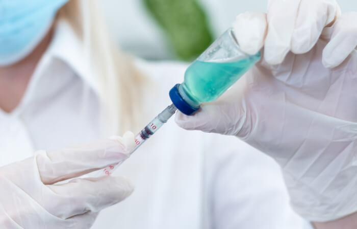 Medical profession filling in the syringe with serum treatment