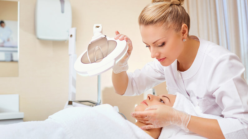 A patient and a dermatologist in a treatment session